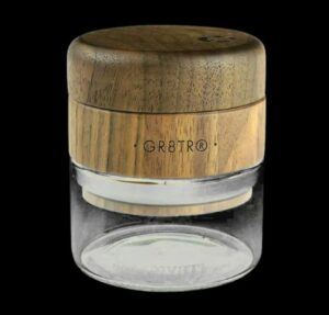 The RYOT Walnut Wood Top GR8TR Grinder with Glass Jar for a Gr8ter Grind