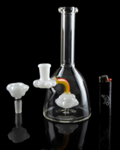 The Rainbow Cloud beaker bong wit the bowl and a lighter sitting beside the bong. Why taste the rainbow when you can SMOKE IT?